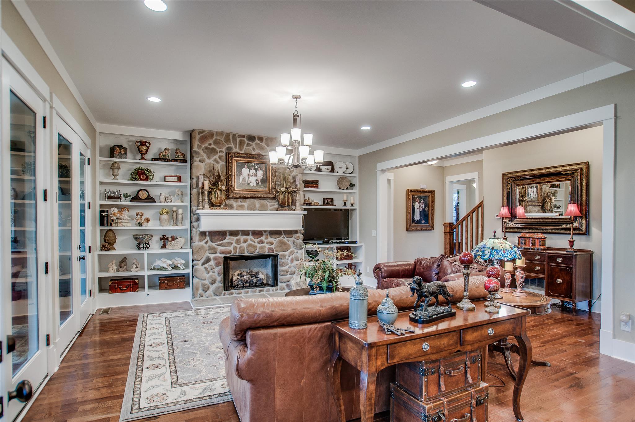 2533 Belle Brook Drive Franklin, TN 37067 - Photo 9 of 30 a living room with furniture a fireplace and a chandelier