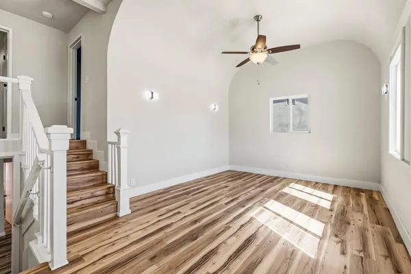 a view of a room with wooden floor and white walls