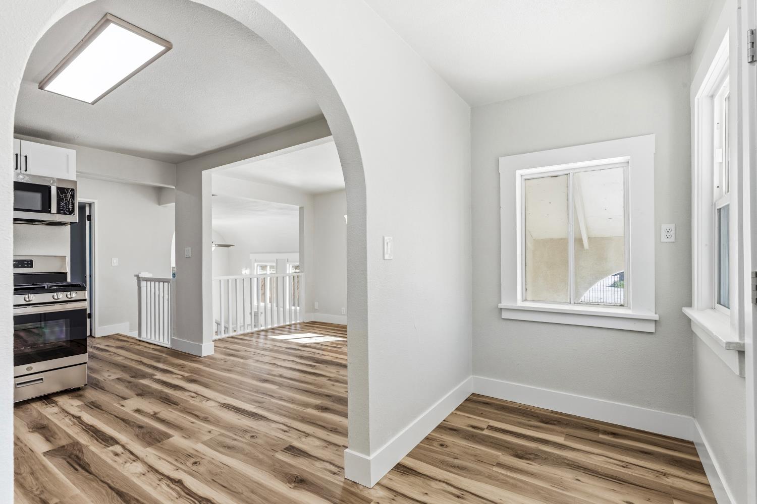 1821 River Road Modesto, CA 95351 - Photo 23 of 50 a view of a hallway with wooden floor and a living room