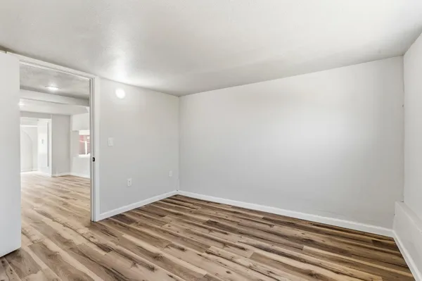 a view of a room with wooden floor and window