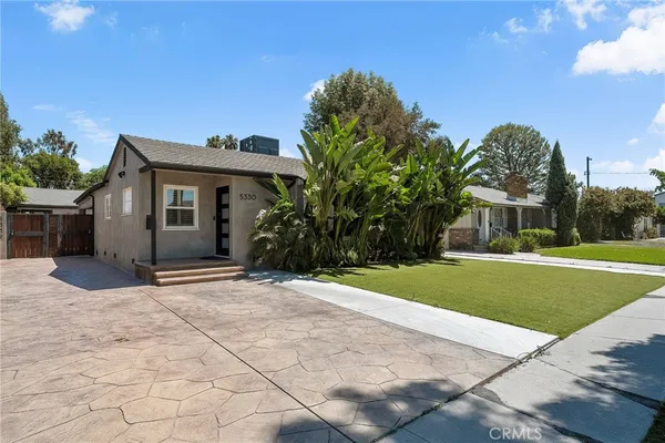 a view of a house with a yard and a garage