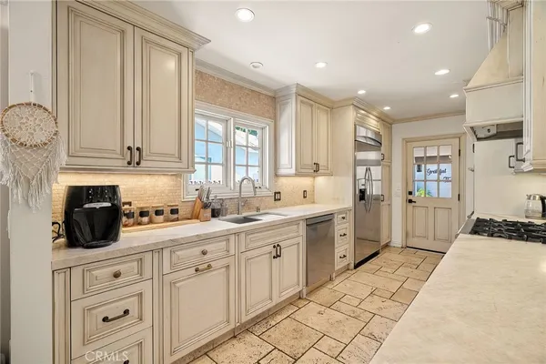 a kitchen with a sink window and cabinets