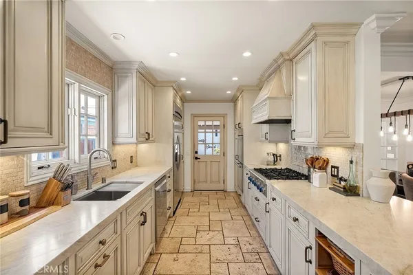 a large kitchen with stainless steel appliances granite countertop a lot of counter space and a sink