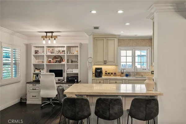 a kitchen with a sink cabinets and wooden floor
