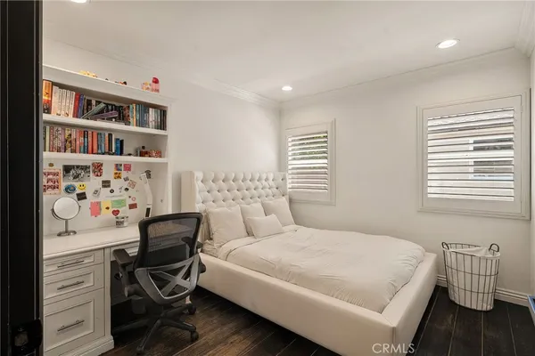 a bedroom with a bed and a chair in it