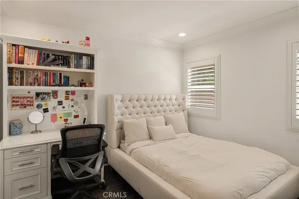 a bedroom with a bed and a book shelf