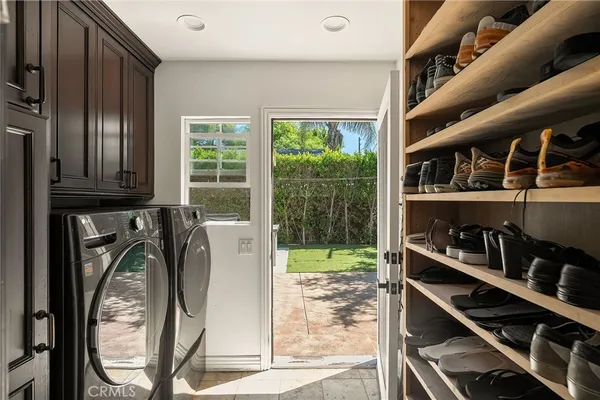 a utility room with multiple dryer and washer
