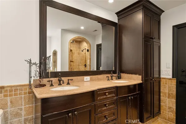 a bathroom with a double vanity sink and a mirror