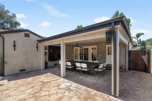 a view of a house with backyard and sitting area