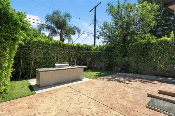 a view of a backyard with a tub and trees