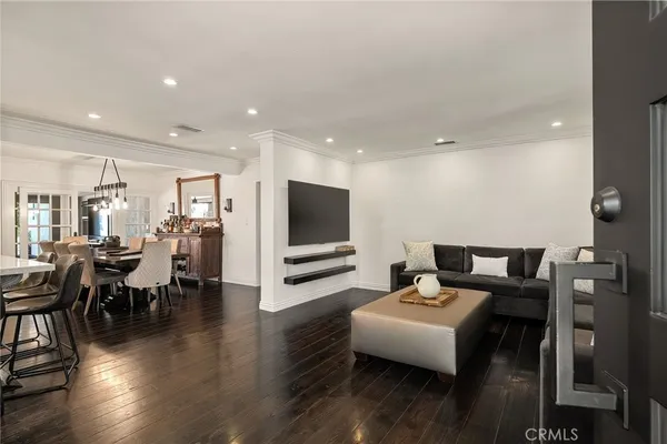 a living room with furniture wooden floor and a flat screen tv