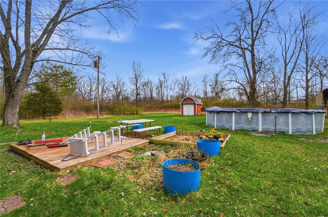 290 Ginghamsburg Road Tipp City, OH 45371 - Photo 45 of 49 This spacious backyard features an above-ground pool, a charming shed, and ample green space.
