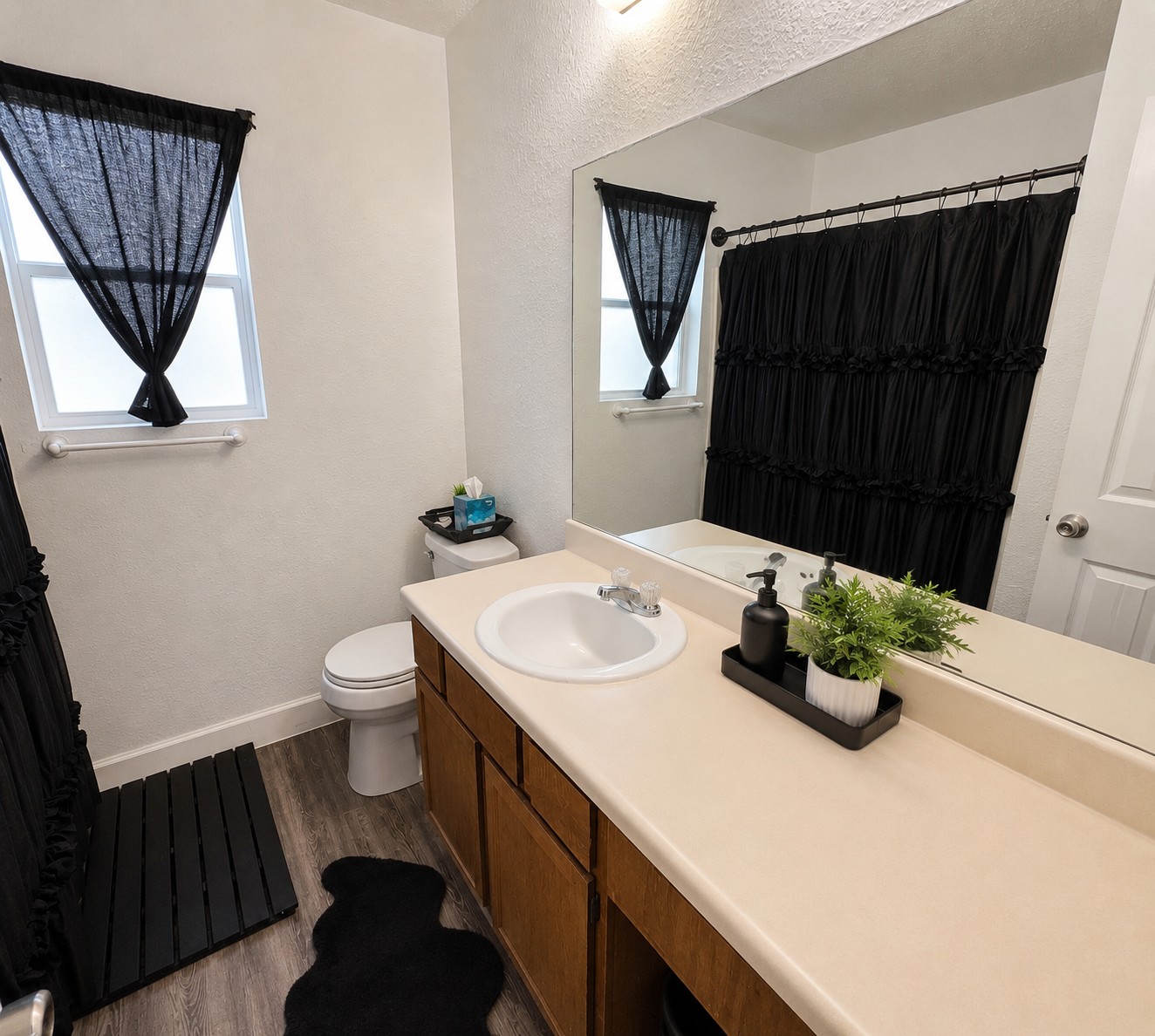 2013 Margalene Way Austin, TX 78728 - Photo 15 of 19 A well-appointed bathroom features a single vanity, a wide mirror, and a convenient window.