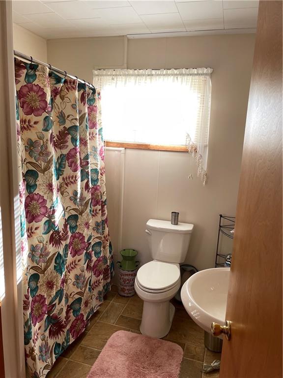 373 State Rte 1028 Dayton, PA 16222 - Photo 18 of 18 a white toilet sitting next to a shower curtain