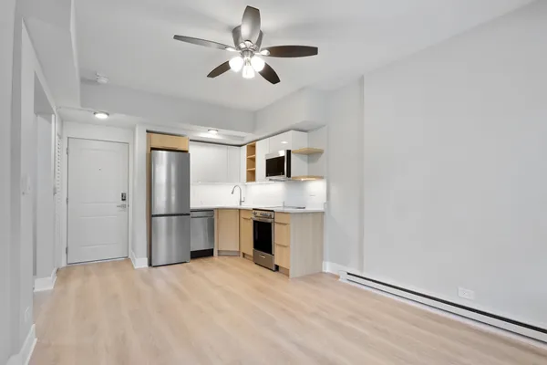 a view of a kitchen with a sink and a refrigerator