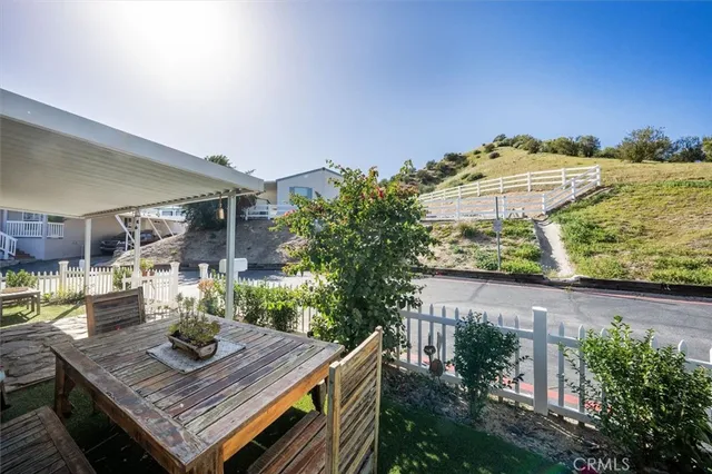 a view of a patio with table and chairs and potted plants