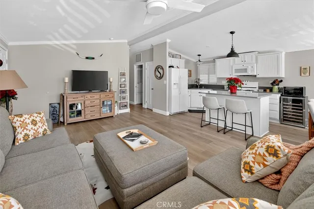 a living room with furniture and kitchen view
