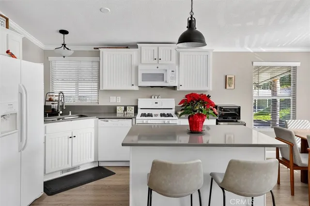 a kitchen with stainless steel appliances granite countertop a white cabinets and a stove