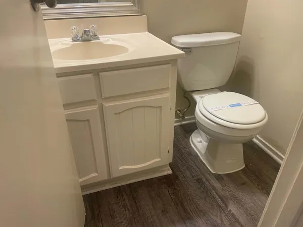 a white toilet sitting next to a sink