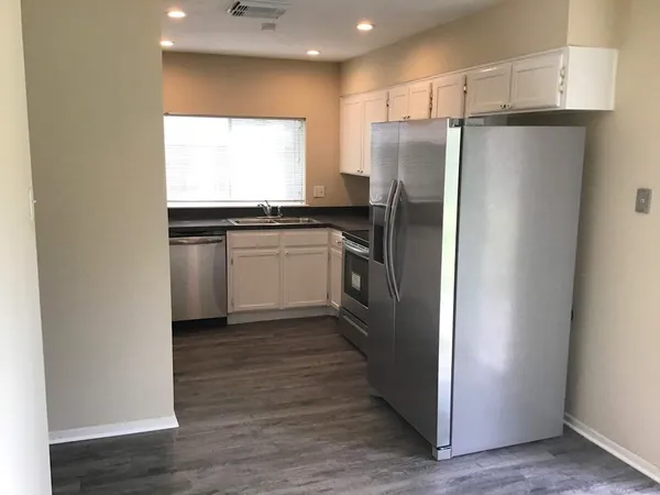a kitchen with stainless steel appliances a refrigerator and a stove
