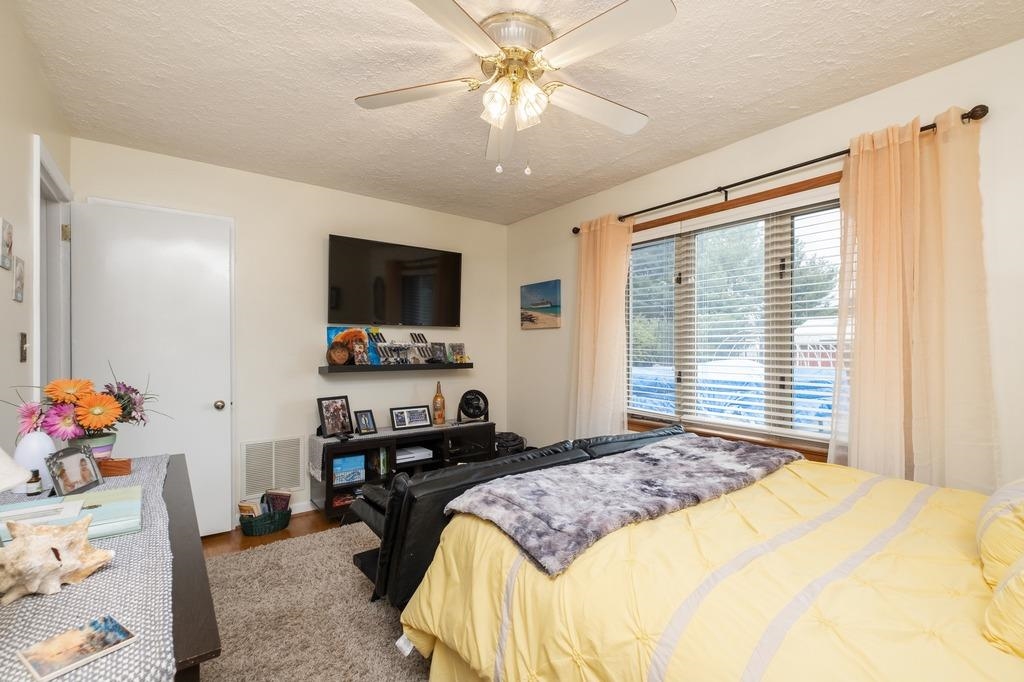1008 Ladd Road Waynesboro, VA 22980 - Photo 8 of 46 a bedroom with a bed and a flat tv screen