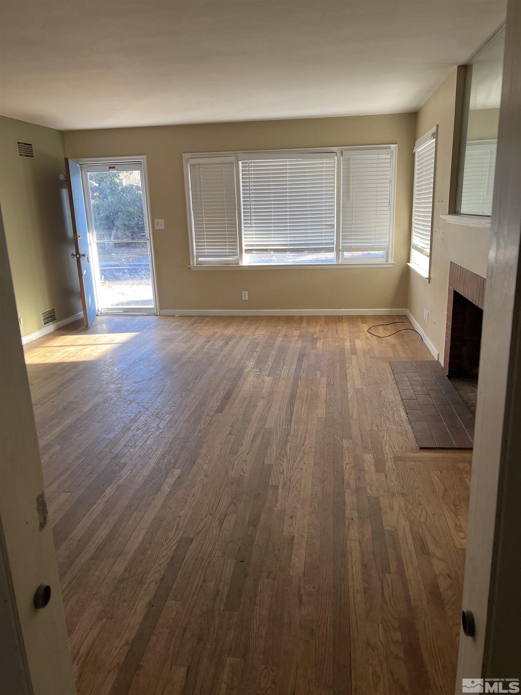 1575 Allen Street Reno, NV 89509 - Photo 3 of 8 wooden floor in an empty room with a window