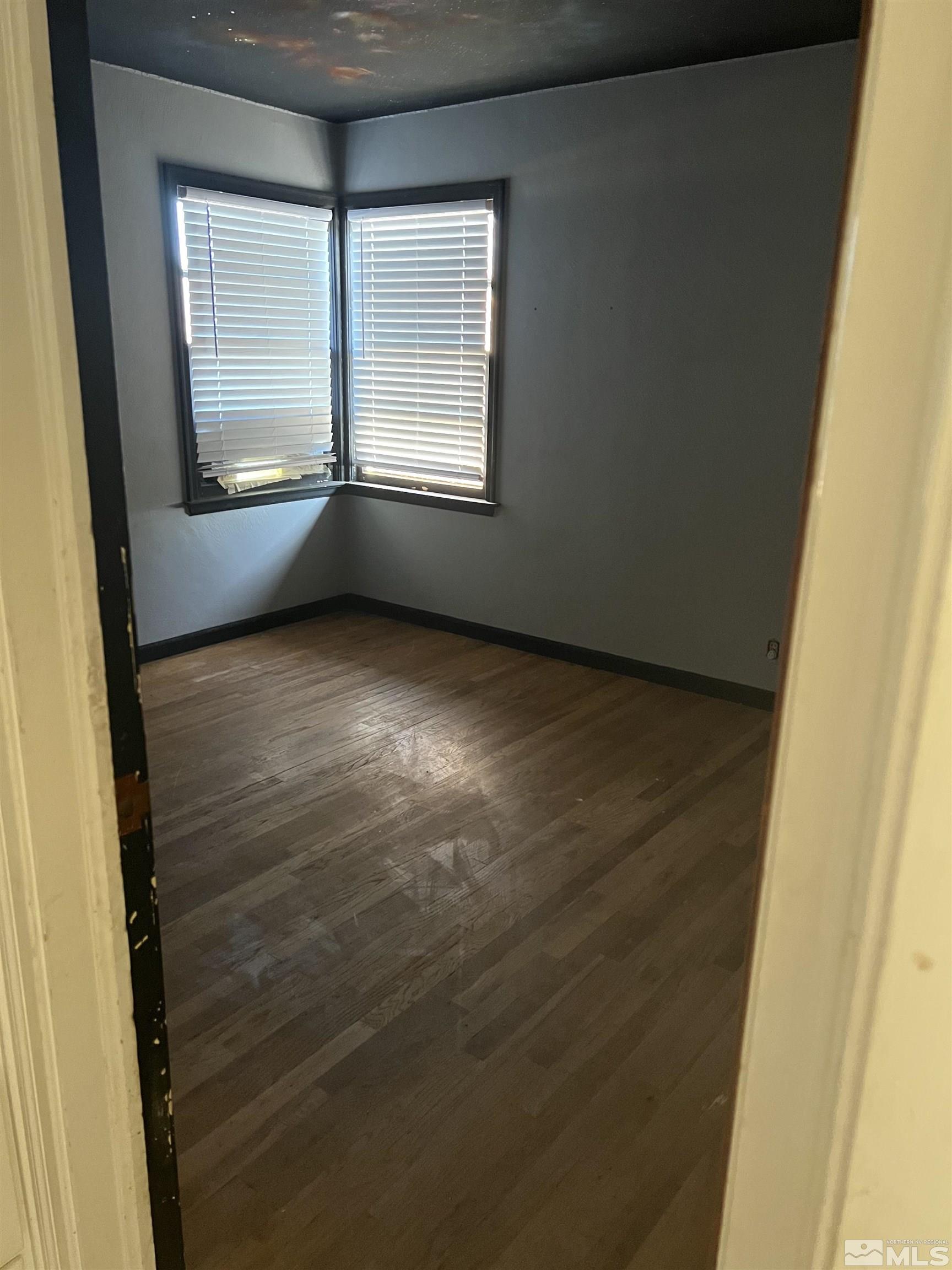1575 Allen Street Reno, NV 89509 - Photo 6 of 8 a view of an empty room with a window and wooden floor