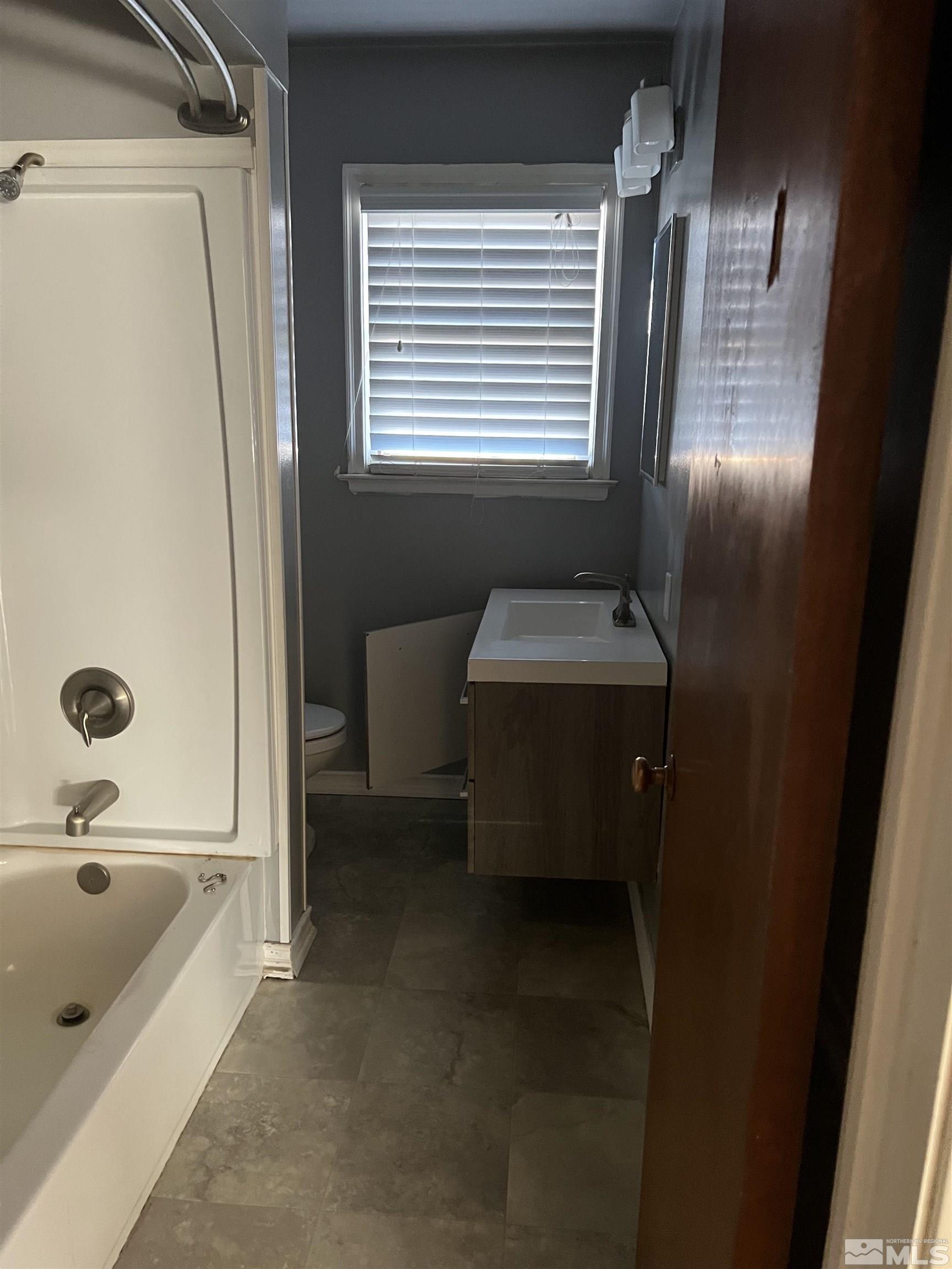 1575 Allen Street Reno, NV 89509 - Photo 7 of 8 a bathroom with a tub sink and a mirror
