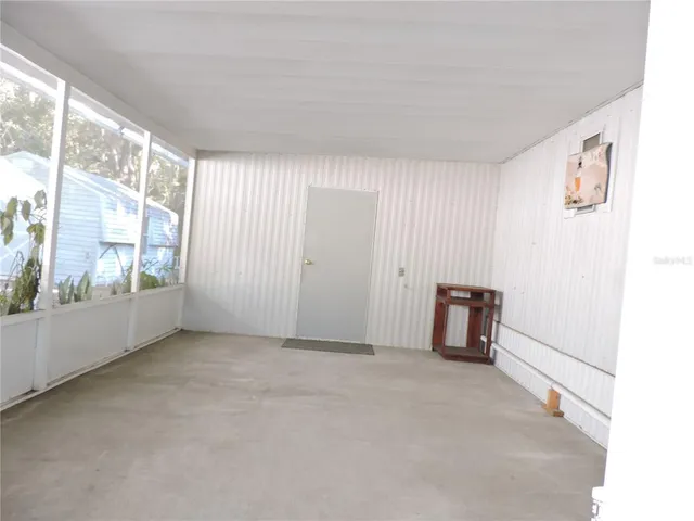 a kitchen with refrigerator and cabinets