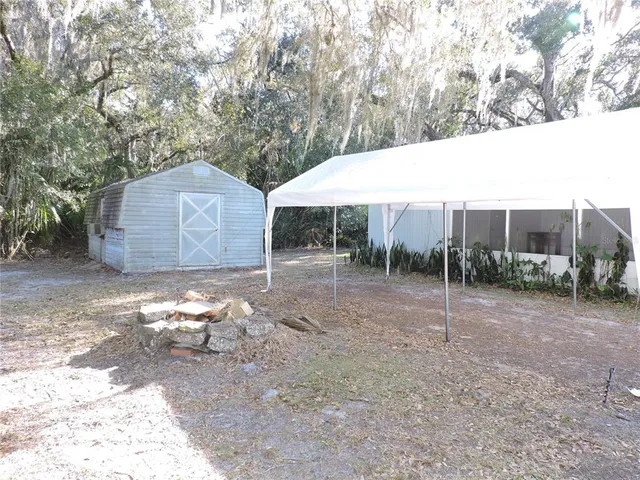 a backyard of a house with lots of green space and garden