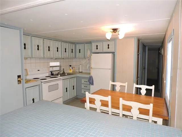 a dining room with a table chairs and entryway