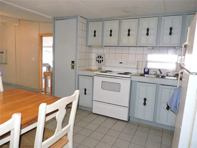 a kitchen with stainless steel appliances granite countertop a sink and cabinets