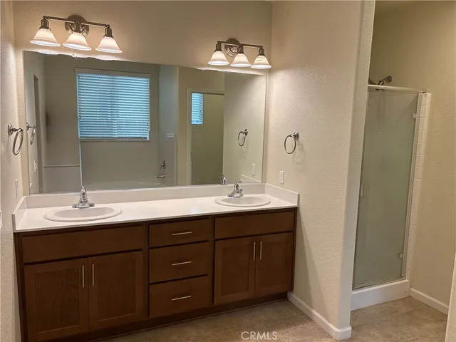 a bathroom with a double vanity sink and a mirror