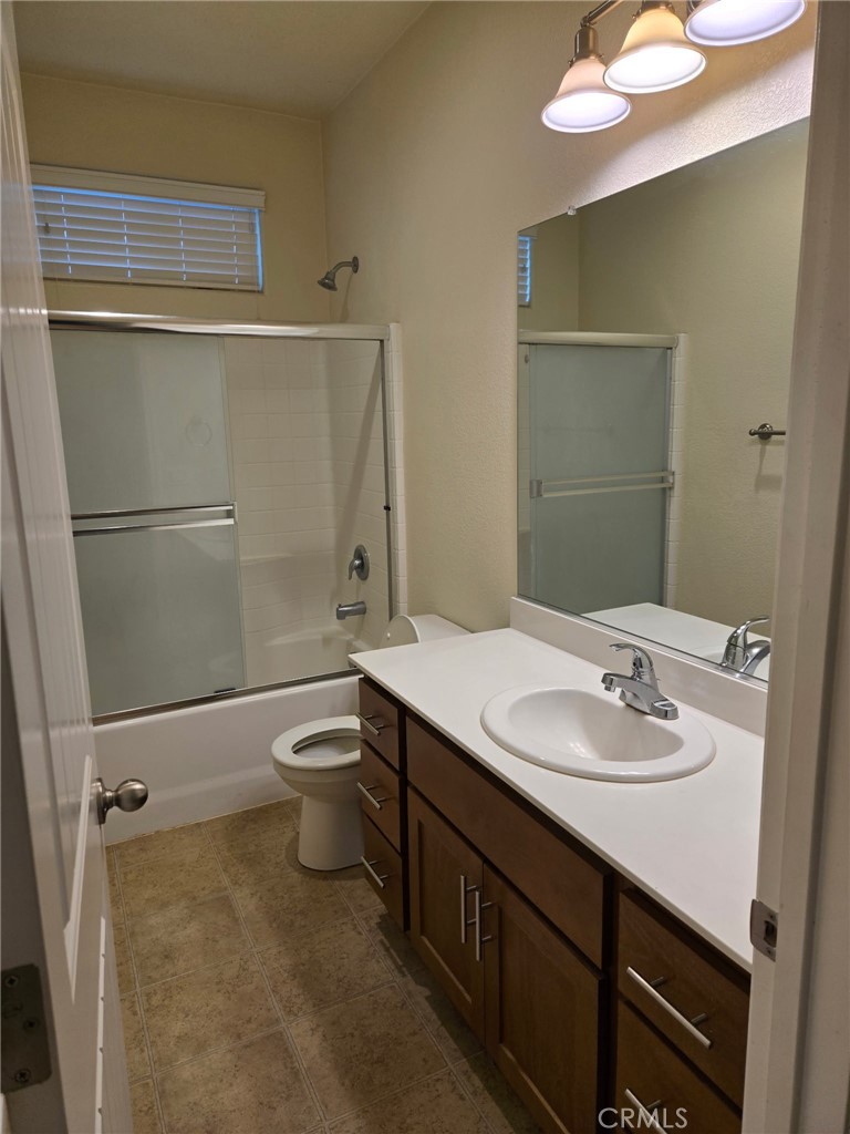 1442 Dynes Street Merced, CA 95348 - Photo 5 of 7 a bathroom with a sink a toilet and shower
