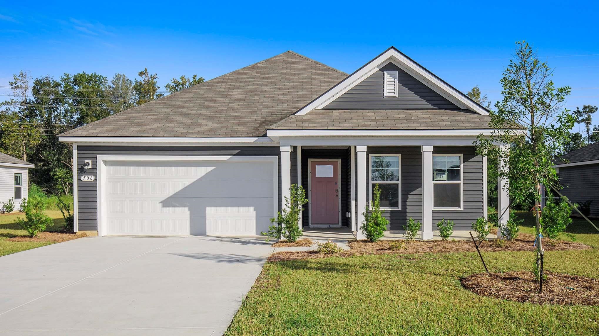 View of front of property featuring a porch, roof with shingles, concrete driveway, a front lawn, and a garage