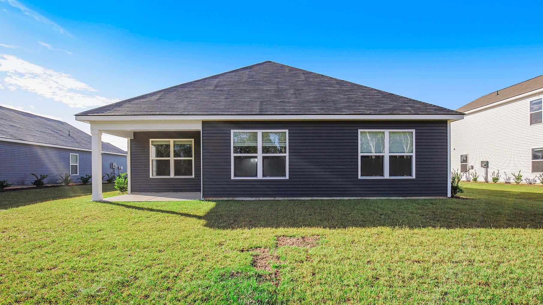 376 Glade Court Loris, SC 29569 - Photo 22 of 22 Rear view of property featuring a patio, a yard, and roof with shingles