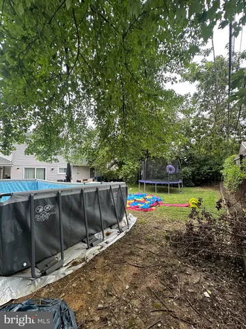 a view of a backyard with swimming pool