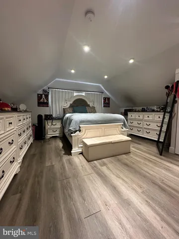 a spacious bedroom with a bed and a view of bedroom