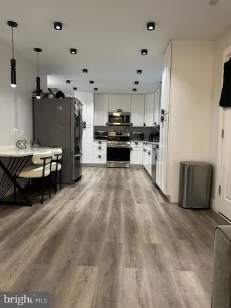 a kitchen with furniture and a refrigerator
