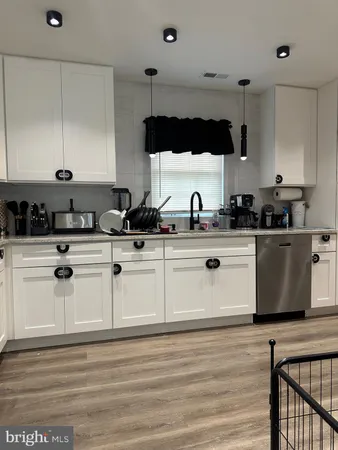 a kitchen with a sink cabinets and stainless steel appliances