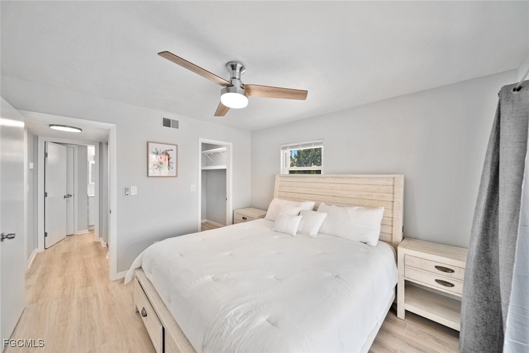 16881 Davis Road, Unit 721 Fort Myers, FL 33908 - Photo 16 of 23 a bedroom with a bed and a chandelier