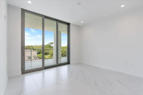 an empty room with large windows