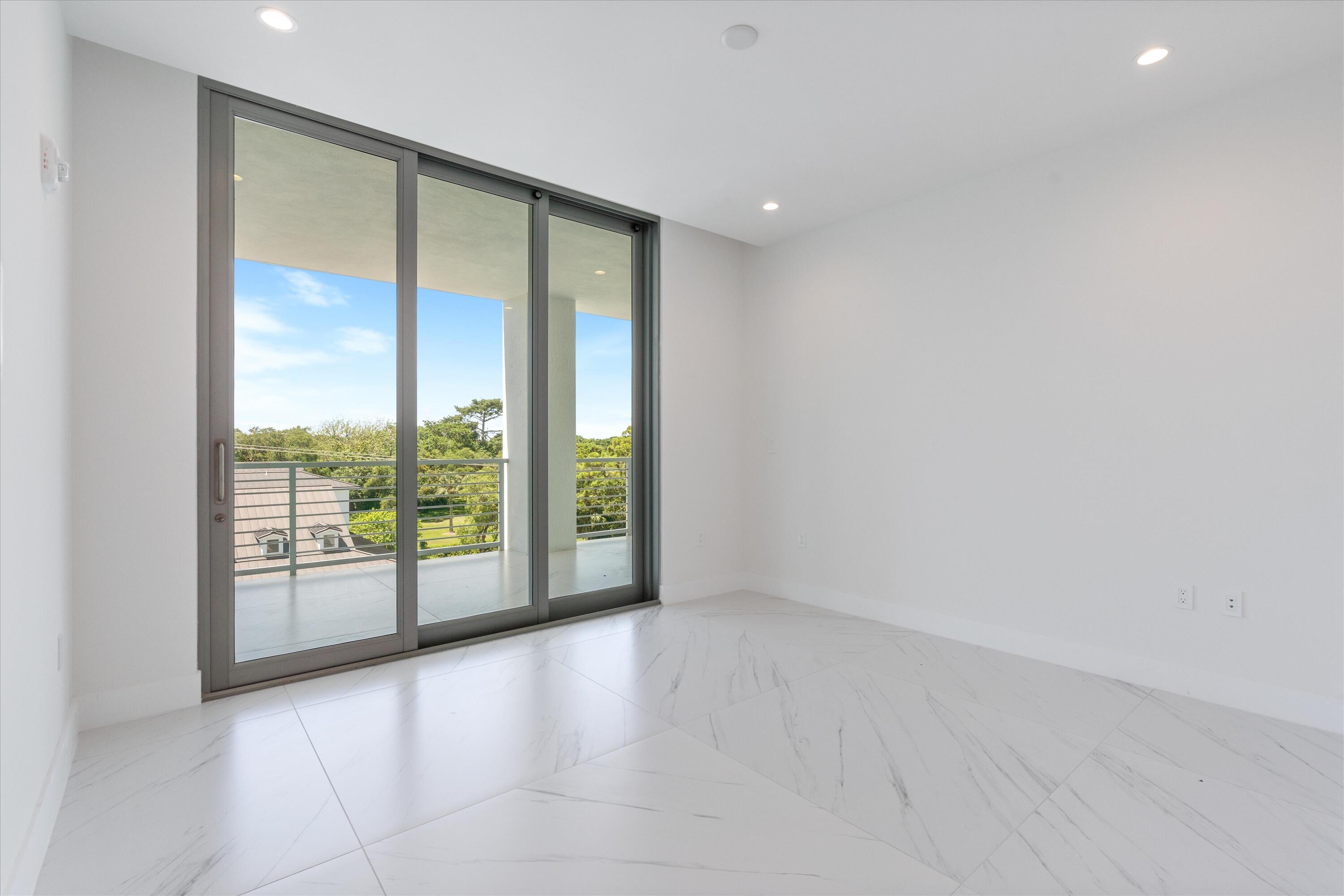 495 East Royal Palm Road, Unit 402 Boca Raton, FL 33432 - Photo 30 of 72 an empty room with sliding glass door and garden view