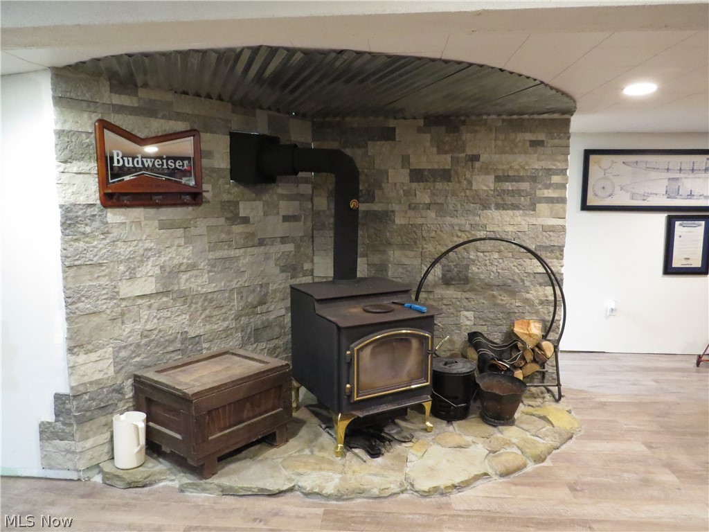 9811 Church Road Huron, OH 44839 - Photo 25 of 28 Interior details featuring hardwood / wood-style flooring and a wood stove