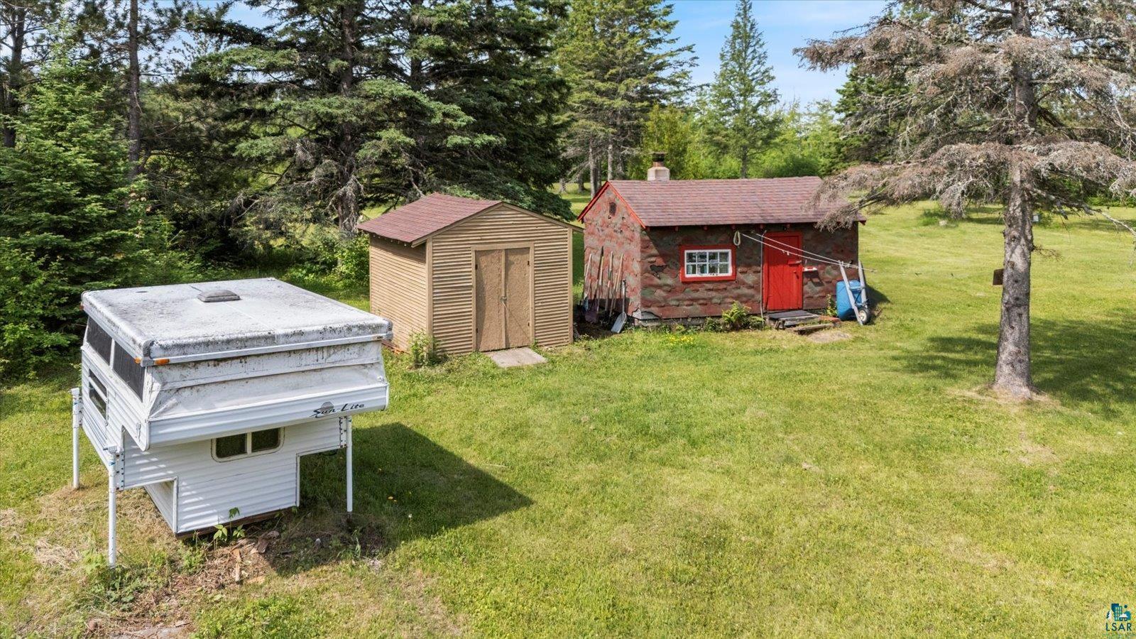 480 Rikala Brimson, MN 55602 - Photo 17 of 38 View of green lawn with sauna and shed