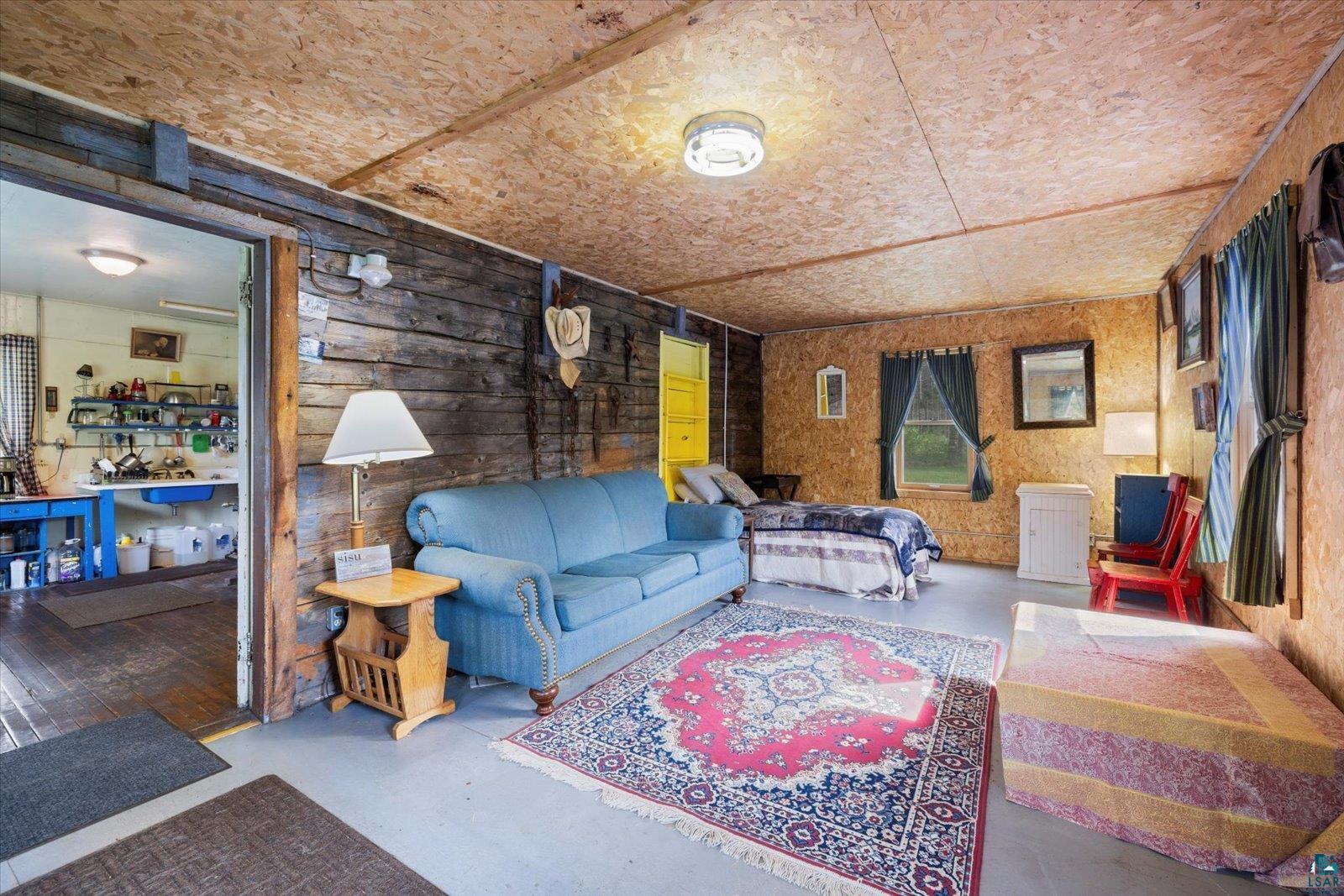 480 Rikala Brimson, MN 55602 - Photo 25 of 38 Living room featuring wooden walls and finished concrete flooring