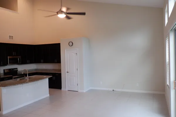 a kitchen with stainless steel appliances granite countertop a sink and a refrigerator