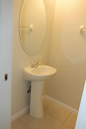 a bathroom with a granite countertop sink a large mirror and toilet