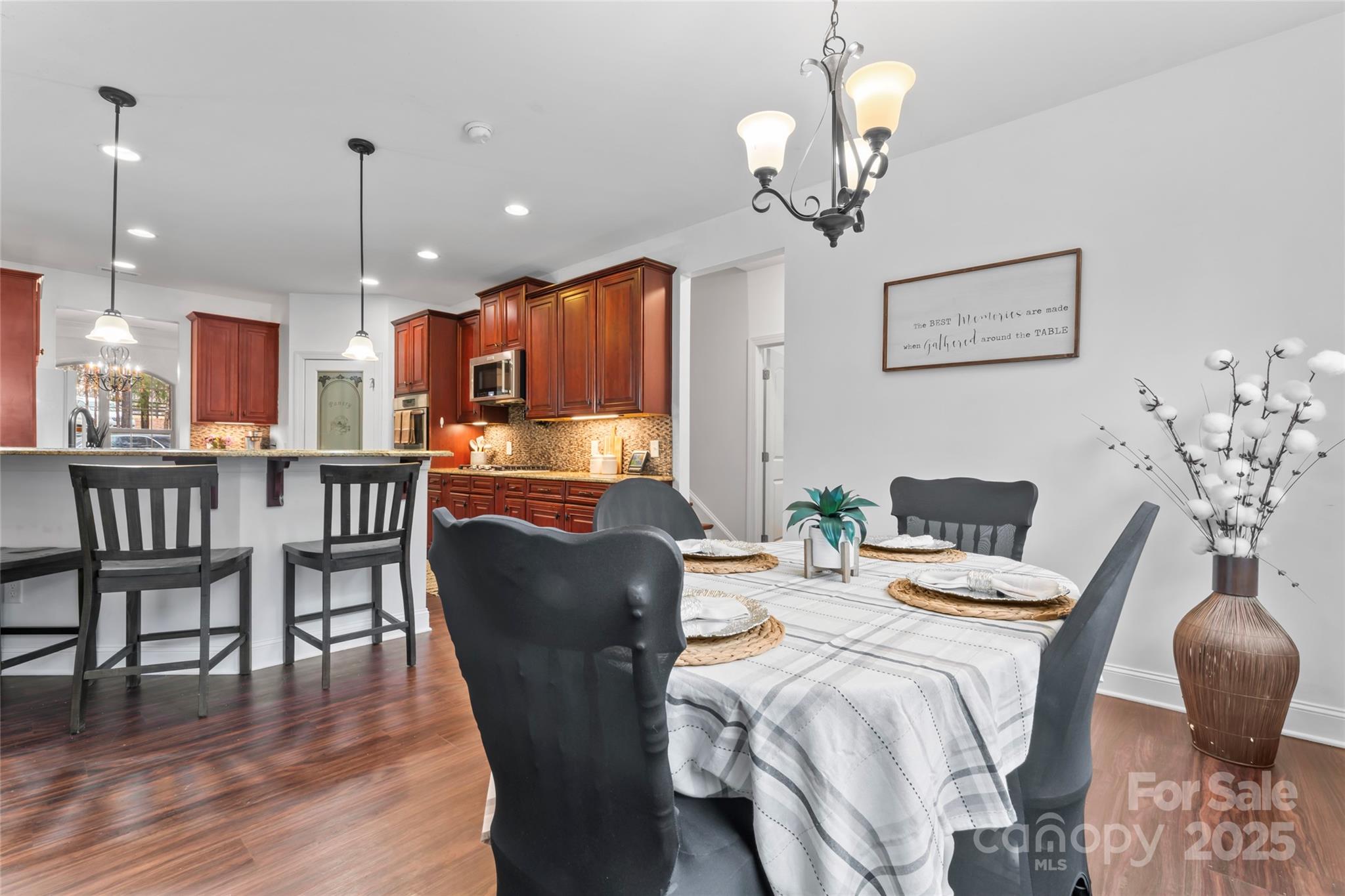 1485 State Rd S-46-1102 York, SC 29745 - Photo 12 of 42 a dining room with wooden floor a chandelier a wooden table and chairs