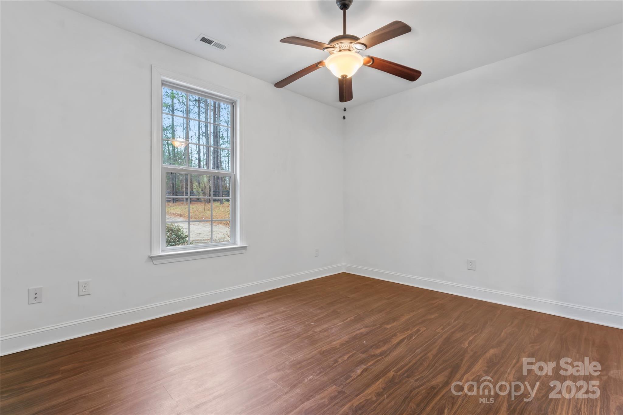 1485 State Rd S-46-1102 York, SC 29745 - Photo 19 of 42 an empty room with wooden floor ceiling fan and windows